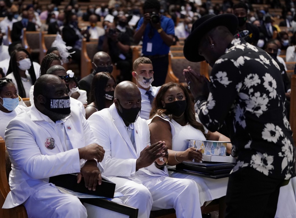Singer Ne-Yo (R) pays respects to the Floyd family at the funeral service for George Floyd at The Fountain of Praise Church on June 9, 2020, in Houston. - George Floyd will be laid to rest Tuesday in his Houston hometown, the culmination of a long farewell to the 46-year-old African American whose death in custody ignited global protests against police brutality and racism.Thousands of well-wishers filed past Floyd's coffin in a public viewing a day earlier, as a court set bail at  million for the white officer charged with his murder last month in Minneapolis. (Photo by David J. Phillip / POOL / AFP)